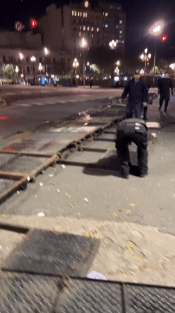 Metal barricades block Buenos Aires crosswalk at night