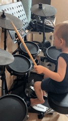 Young boy plays electronic drums in Mytishchi