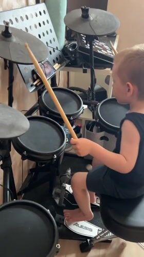 Young boy plays electronic drums in Mytishchi