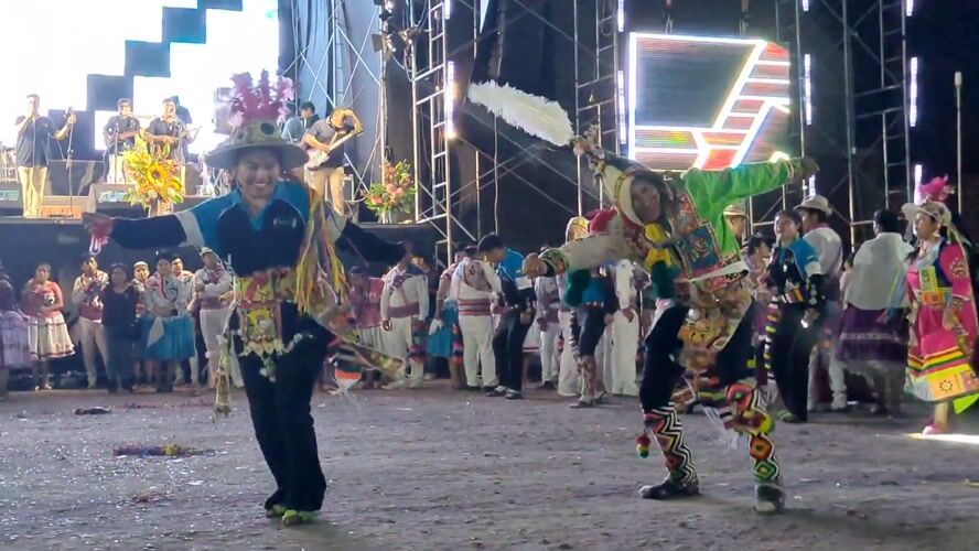 Traditional Andean dancers perform for gathered crowd in Tacna