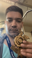 Employee displays bronze dragon medal on Kazan public transport