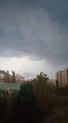 Storm clouds and rain move over a Kyiv neighborhood