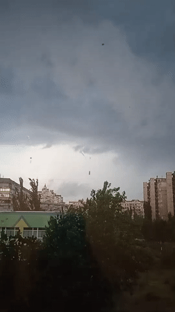 Storm clouds and rain move over a Kyiv neighborhood