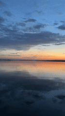 Sunset to twilight transition documented over waterfront area