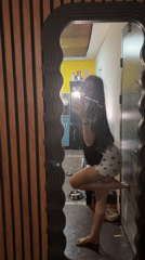 Woman takes mirror selfies in Bulgarian home late evening