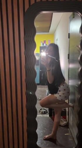 Woman takes mirror selfies in Bulgarian home late evening