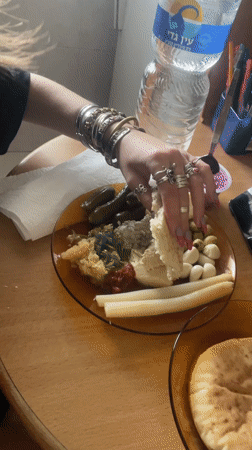 Woman enjoys traditional Middle Eastern breakfast in Petah Tikva