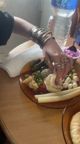 Woman enjoys traditional Middle Eastern breakfast in Petah Tikva