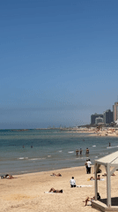 Tel Aviv beachgoers enjoy sunny Mediterranean morning