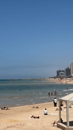 Tel Aviv beachgoers enjoy sunny Mediterranean morning