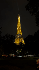 Eiffel Tower glows golden with beacon active Saturday evening