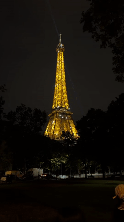 Eiffel Tower glows golden with beacon active Saturday evening