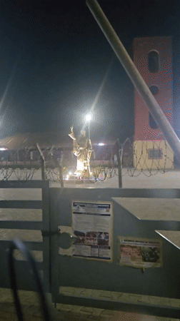 Illuminated religious statue observed at Nigerian parish at night
