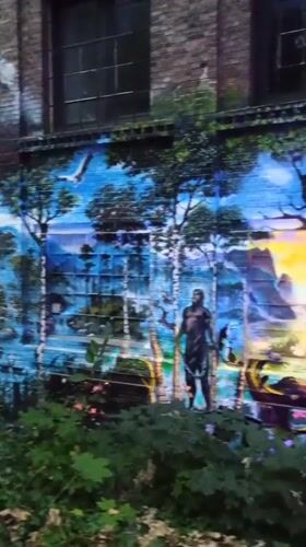 Surreal futuristic mural covers building wall in Iserlohn