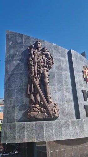 Woman brings flowers to WWII memorial in Otchor, Russia