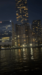 London skyline lights shimmer across Thames in evening footage