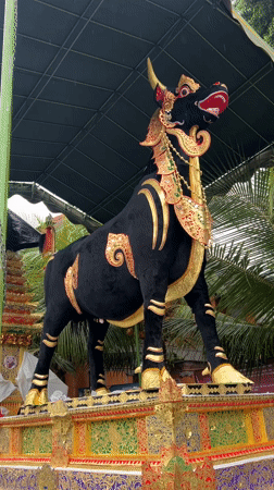Tourist documents Balinese temple art and Hindu statues in Ubud