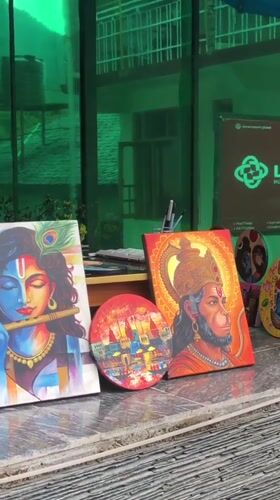 Hindu deity paintings displayed at outdoor market in Haini