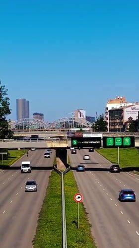 Aerial view of Riga highway traffic with city skyline behind