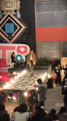 Outdoor runway show in La Paz, flames and geometric mural backdrop
