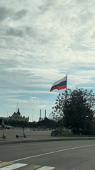 Russian flag waves over Sirius cityscape with landmark buildings