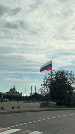 Russian flag waves over Sirius cityscape with landmark buildings