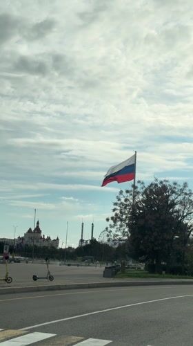Russian flag waves over Sirius cityscape with landmark buildings