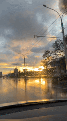 Post-rain sunset on a Minsk boulevard, golden light on wet asphalt