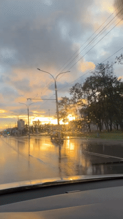 Post-rain sunset on a Minsk boulevard, golden light on wet asphalt