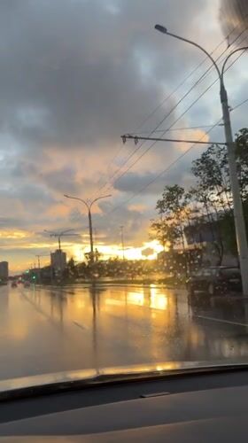 Post-rain sunset on a Minsk boulevard, golden light on wet asphalt