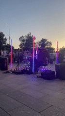 Outdoor drummer draws crowd during sunset performance in public square