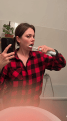 Woman records selfie video in Budapest bathroom mirror