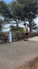 Man rock climbs coastal stones in Montenegro seaside village