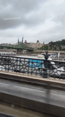River view captured from moving vehicle in Budapest