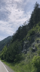 Morning drive past forested mountains captured in Russia