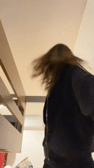 Woman hangs from bunk bed bar in Mexican bedroom