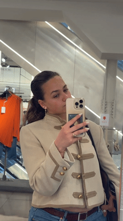 Woman takes shopping selfies near Milan Cathedral during event setup
