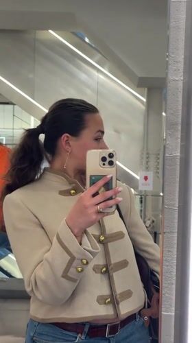 Woman takes shopping selfies near Milan Cathedral during event setup
