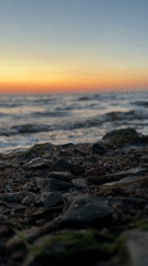 Sunset over a rocky shoreline in Kokshetau, Kazakhstan