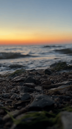 Sunset over a rocky shoreline in Kokshetau, Kazakhstan