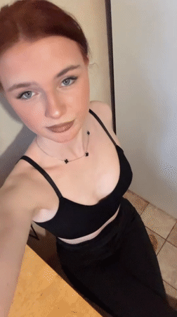 Woman documents daily routine in Murino apartment kitchen