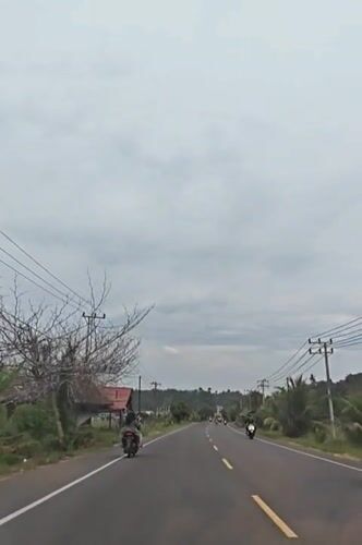 Morning traffic flows on rural Indonesian roads