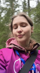 Woman films selfie on zip line course in Russian forest