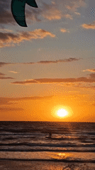 Kitesurfer silhouetted against sunset near Shchelkino, Ukraine