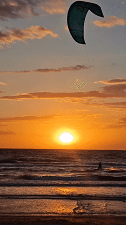 Kitesurfer silhouetted against sunset near Shchelkino, Ukraine