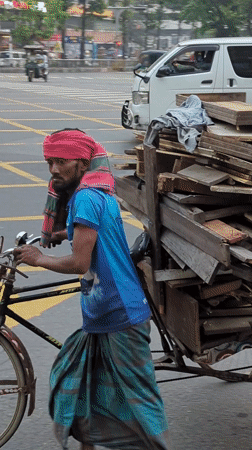 Night transport workers move goods through Dhaka intersections
