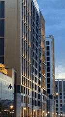 Modern apartment complex and theater in a Russian-speaking city at dusk