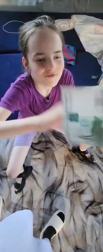 Child enjoys afternoon meal at home in Krasnogorskoye