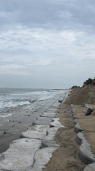 Hoi An's concrete seawall holds the line on an overcast shore