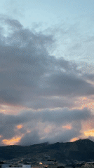 Twilight sky with crescent moon observed over Quito mountains